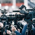 Mystery Idaho Air Show Crash: What’s the Truth? Broadcast cameras on tripods at a press event
