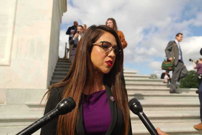 Woman speaking to microphones on stone steps