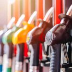 Big Oil In TRUMP’S Crosshairs Now — What’s Getting EXPOSED! Close-up of fuel pump nozzles at a gas station