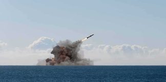 Oil Lifeline Hit — Tehran VOWS PAYBACK Missile launching over the sea with smoke plume
