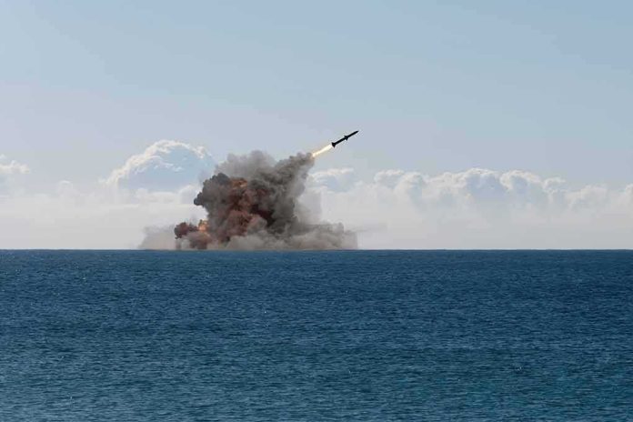 shutterstock_2459904117 Missile launching over the sea with smoke plume