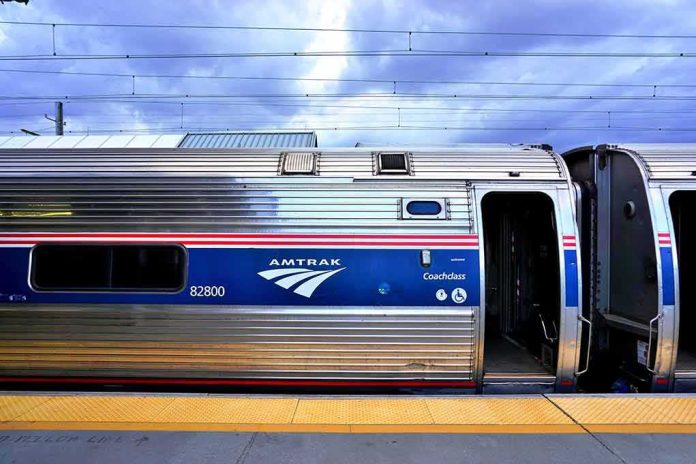 Amtrak coach car at station platform with open door