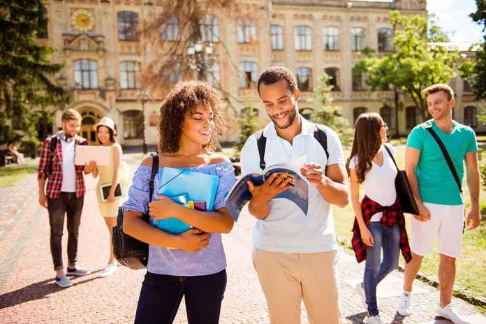 Students walking on campus with books and backpacks
