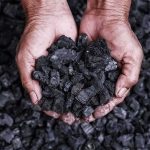 COAL Was On Death Row — Then The WARDEN Changed Hands holding a pile of charcoal pieces