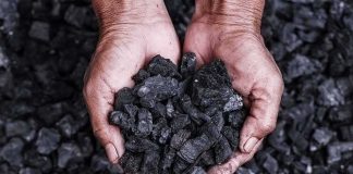 COAL Was On Death Row — Then The WARDEN Changed Hands holding a pile of charcoal pieces