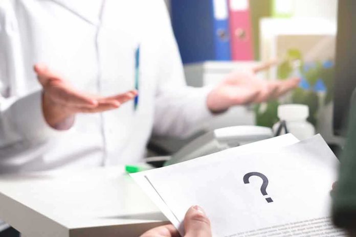 shutterstock_788107000 Doctor gesturing during consultation with patient holding paper with question mark