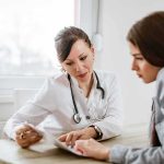Fifth Circuit FREEZE Upends Abortion Pill Access Doctor consulting a patient at a desk