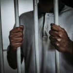Lifer’s SICK Reason To Kill — His Victim Was Almost FREE Person gripping prison bars with both hands
