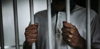 Lifer’s SICK Reason To Kill — His Victim Was Almost FREE Person gripping prison bars with both hands