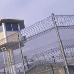 Church KILLER Blamed ONE Thing — Supreme Court Just ANSWERED Prison watchtower behind barbed wire fencing