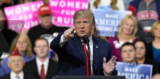 Trump’s Newly Launched Project READS Like Science Fiction Donald Trump speaking at a rally podium, pointing toward the audience