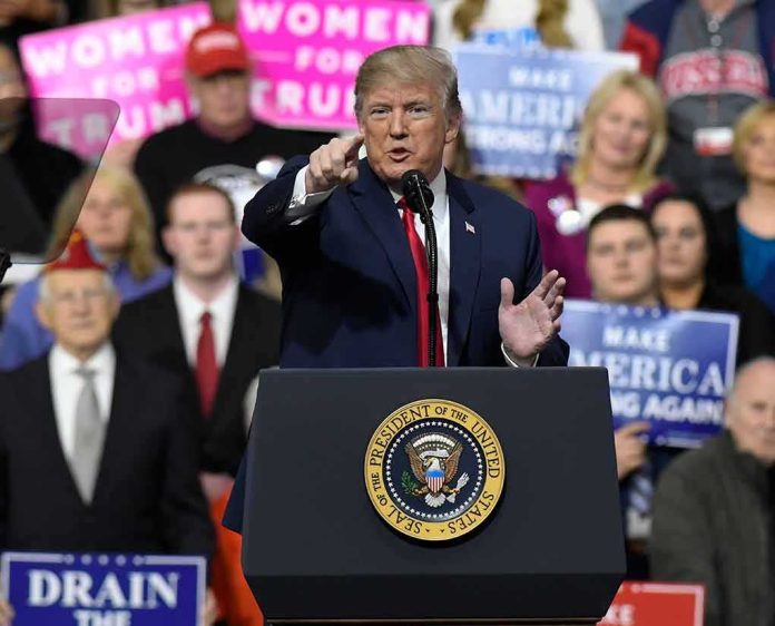 shutterstock_1046190946 Donald Trump speaking at a rally podium, pointing toward the audience