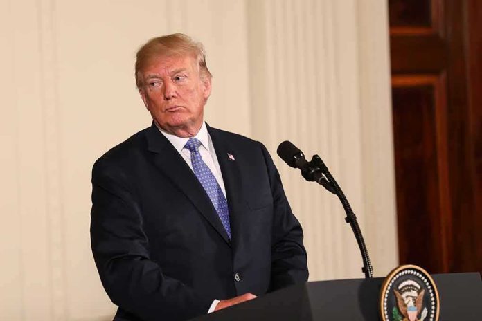 shutterstock_1081476917 Donald Trump at a podium with microphone