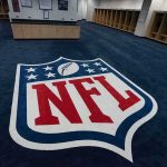Top NFL Voice OUT After 9 Years — LOOK Who Has His Chair NFL logo on the floor of an empty locker room