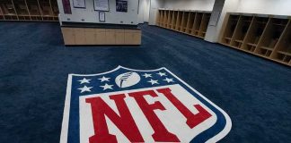 Top NFL Voice OUT After 9 Years — LOOK Who Has His Chair NFL logo on the floor of an empty locker room