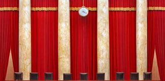 Supreme Court Showdown With TRUMP Smack In The MIDDLE Supreme court courtroom with red curtains and empty judges' bench