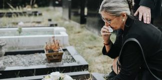 CELEBRITY’S Case Closed — What The Coroner FINALLY Found Woman placing flowers at a grave in a cemetery