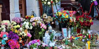 Two Boys GUNNED DOWN — What The Shooters POSTED After Memorial with flowers, candles, and tributes on a sidewalk