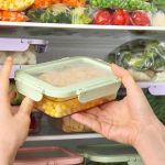 RECALL: More Frozen Berries Added. The Bag May Be In YOUR Freezer Hands placing a food container in a freezer