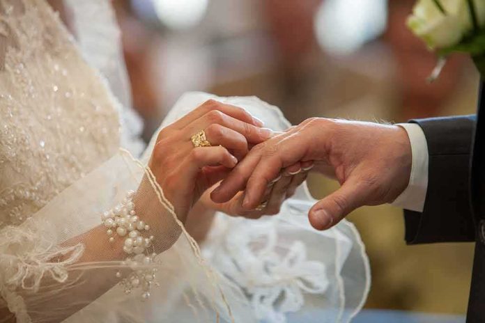 Bride placing ring on groom's finger