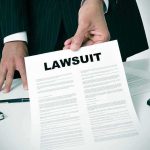 ABSURD $5M CANDY Lawsuit Hits a New LOW Businessperson holding a lawsuit document at a desk