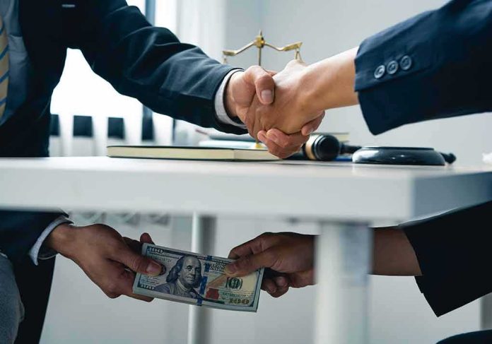 businesspeople handshake with hidden cash exchange under table