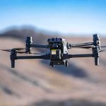Engineer Bought BOMB Chemicals, Feds Say — While On OUR Payroll Quadcopter drone hovering outdoors over a blurred landscape