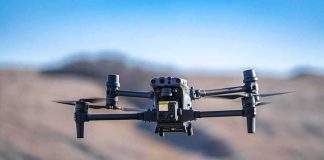 Engineer Bought BOMB Chemicals, Feds Say — While On OUR Payroll Quadcopter drone hovering outdoors over a blurred landscape
