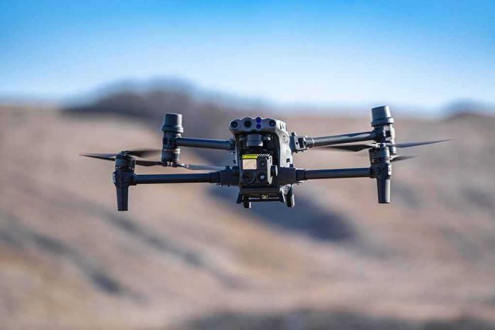 Quadcopter drone hovering outdoors over a blurred landscape