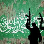 Chilling Note Found In Terrorist’s Sock silhouettes of armed figures in front of a weathered green wall with white script
