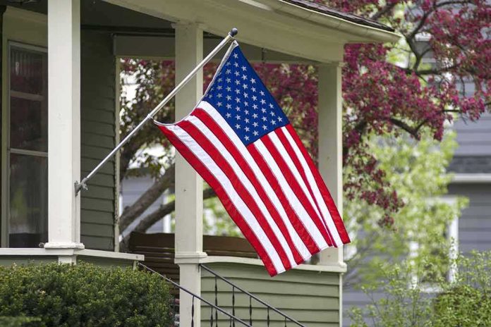 shutterstock_274747697 American flag hanging from a house porch