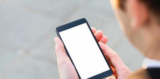 Accused Of A SICK 2-Year Plot, He Texted The WRONG Guy Person holding smartphone with blank white screen