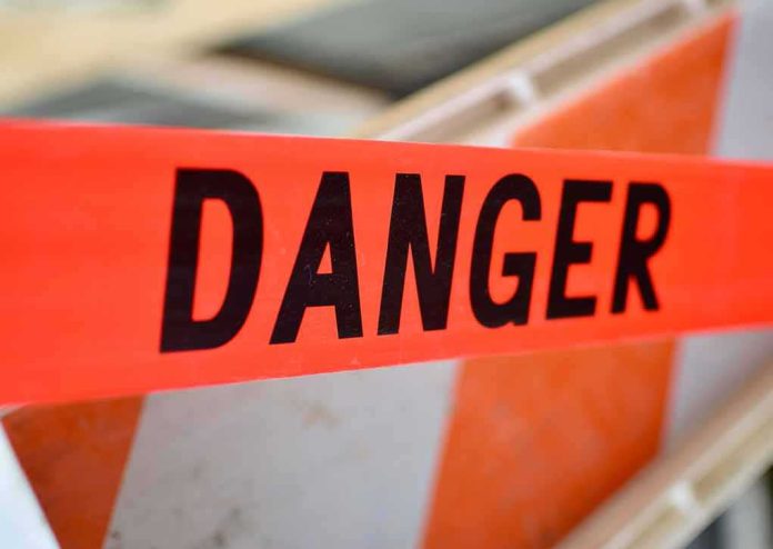shutterstock_359320793 Danger tape at a construction barrier