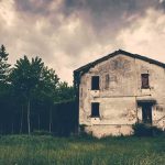 Backup Cop At Death Scene Now ACCUSED abandoned house in a field under stormy sky