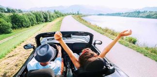 Supreme Court Order HITS Gun Owners Couple in a convertible driving along a lakeside road