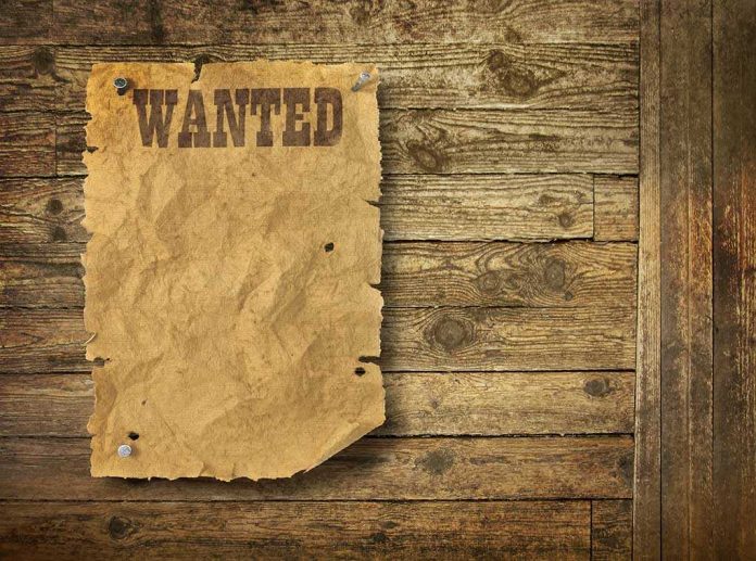 shutterstock_89947687-3 A vintage wanted poster pinned to a wooden wall
